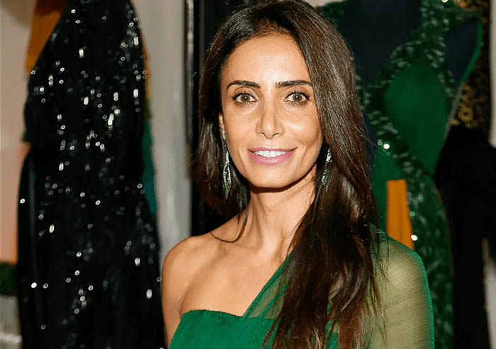 Abeer Al Otaiba in an emerald dress with off-the-shoulder matching shear shall, photographed by Paul Morigi.