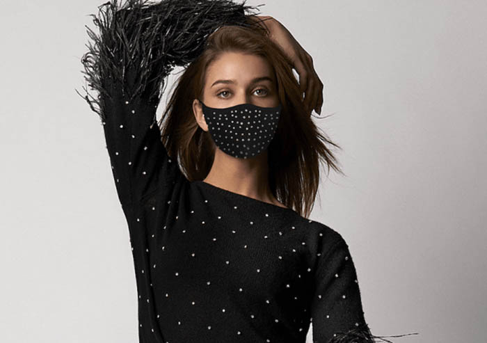 Model poses in a black SemSem dress with matching black SemSem face mask designed by Abeer Al Otaiba, 2020.