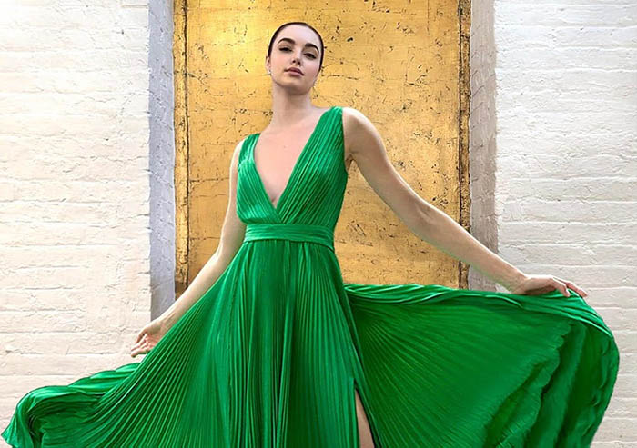 Model shows off SemSem’s Fall/Winter 2024 collection with a flowing green gown.